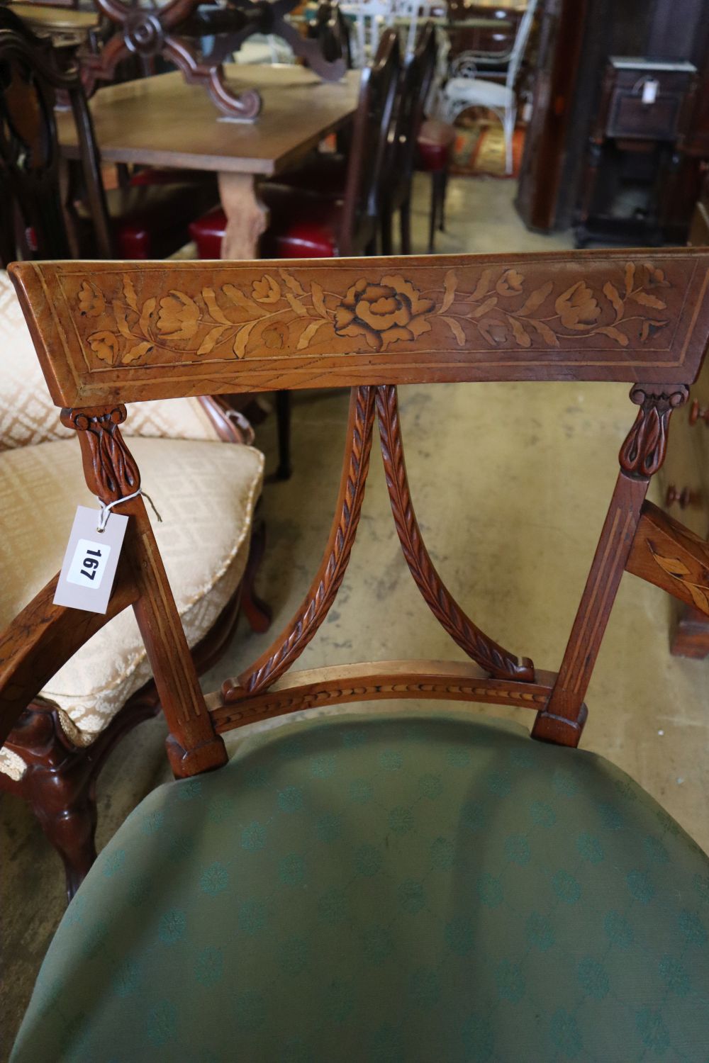An early 19th century Dutch floral marquetry inlaid elbow chair